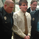 Police officers take Denny Marzano into custody following his
latest romantic-comedy-like crime.